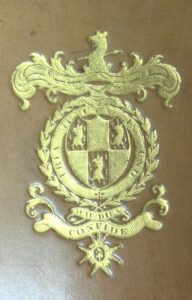 The coat of arms of William Carr Beresford, first Viscount of Beresford tooled and gilt onto the tan leather binding of a book.